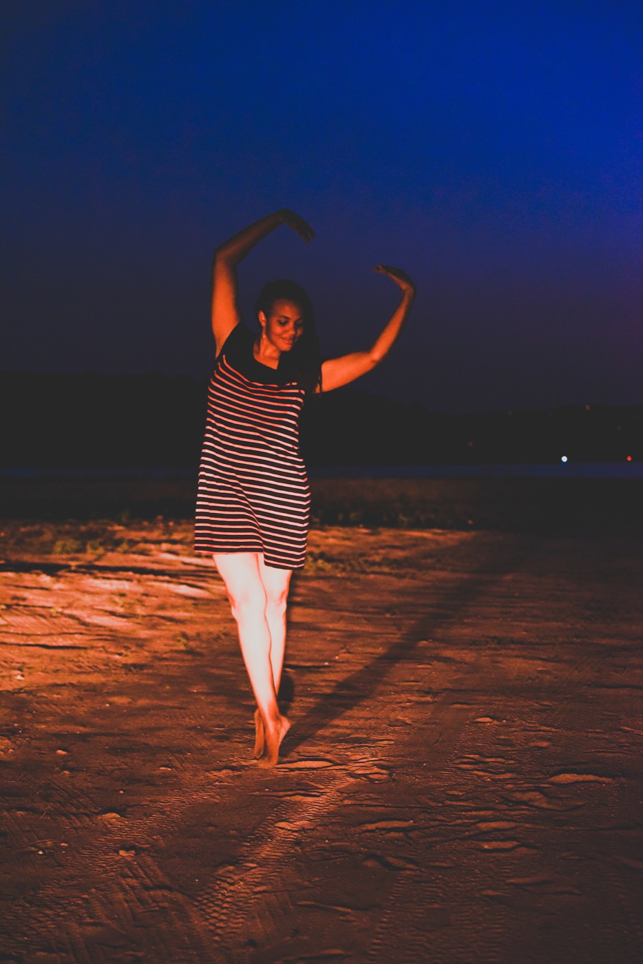 Dionne dancing on the beach at sunset