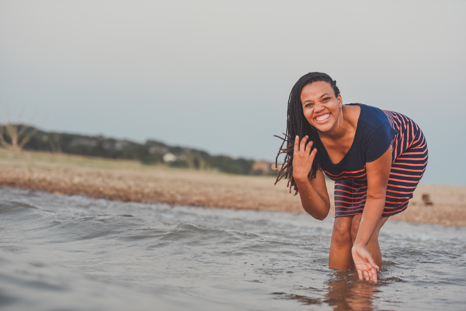 Dionne smiling in the water at sunset